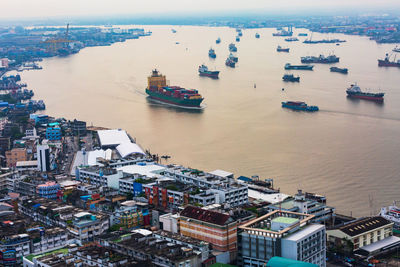 High angle view of buildings by sea against sky