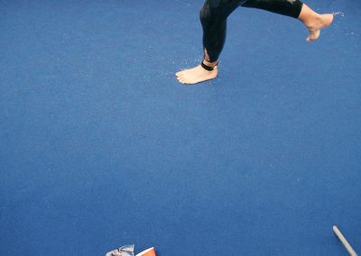 Low section of woman standing on tiled floor