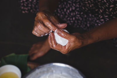 High angle view of woman making rice cake