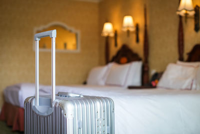 Close-up of illuminated lighting equipment on bed at home