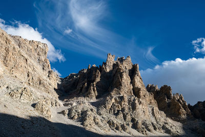 Low angle view of rock formations against sky