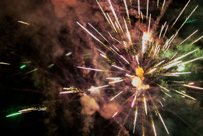 Low angle view of firework display at night