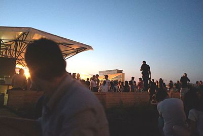 Silhouette of woman against clear sky at sunset