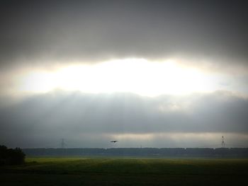 Scenic view of field against sky during foggy weather