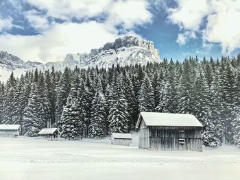 Built structure on snow covered landscape against sky