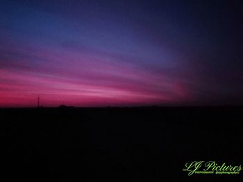 Scenic view of silhouette field against sky at sunset
