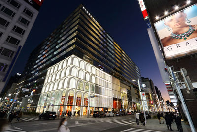 Low angle view of buildings in city at night