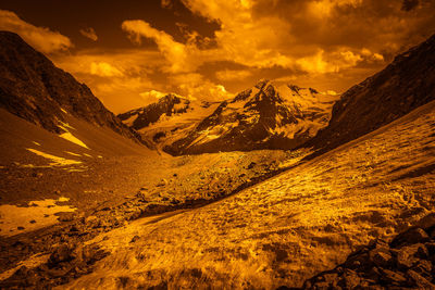 Scenic view of snowcapped mountains against sky during sunset