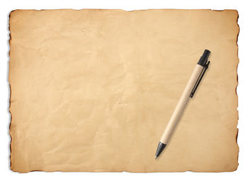 High angle view of pen on paper against white background