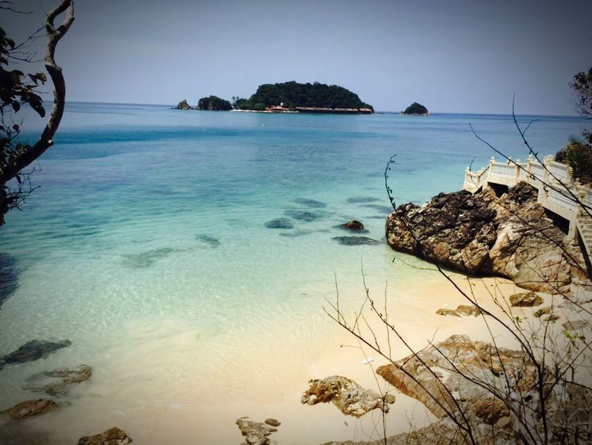 water, sea, tranquil scene, tranquility, horizon over water, scenics, clear sky, beauty in nature, beach, nature, shore, sky, idyllic, rock - object, coastline, tree, plant, non-urban scene, calm, outdoors