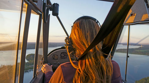 Rear view of woman flying air vehicle