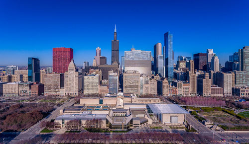 Modern buildings in city against blue sky