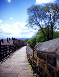 Surface level of footpath against the sky