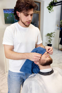 Side view of man with teddy bear