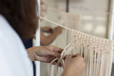 Cropped image of woman doing macrame