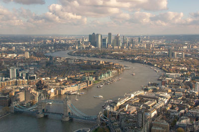 High angle view of city by river against buildings
