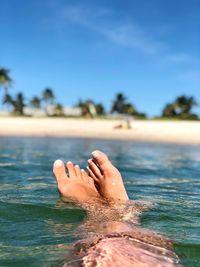 Low section of person relaxing in sea