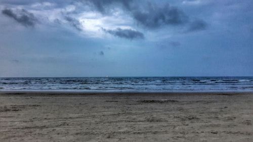 Scenic view of sea against cloudy sky