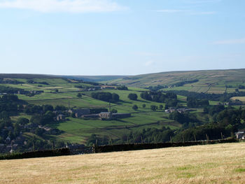 Scenic view of agricultural field against sky