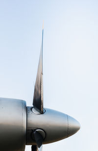 Low angle view of airplane flying against clear sky