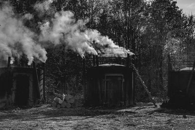 Smoke emitting from chimney on field