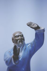 Low angle view of statue against blue background