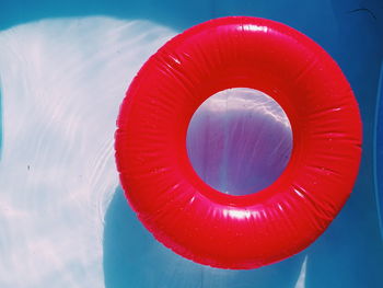 Close-up of red floating on water against sky