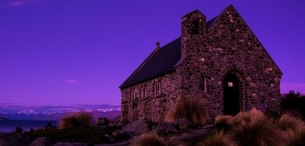 Castle by tree against sky