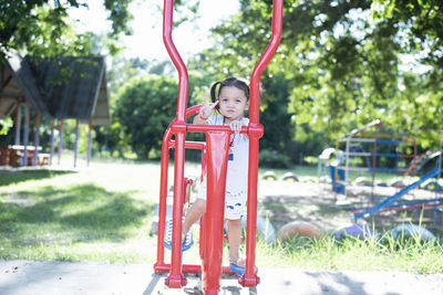 Rear view of woman sitting on swing