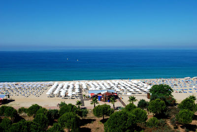 High angle view of sea against clear blue sky