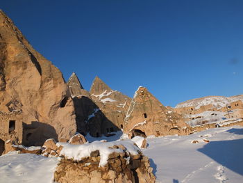 Scenic view of snowcapped mountains against clear blue sky