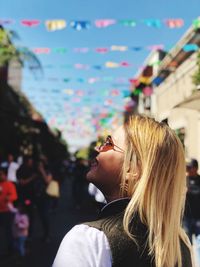 Woman with blond hair standing in city