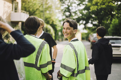 Portrait of smiling boy walking with friend