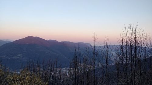 Scenic view of mountains against clear sky during sunset