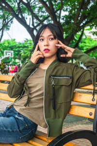 Portrait of young woman sitting on seat