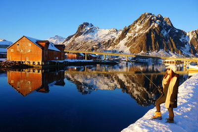 Reflection of mountains in lake against clear blue sky