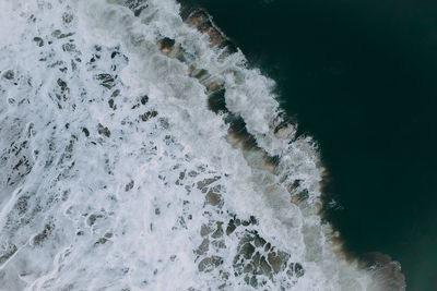 High angle view of water flowing over sea