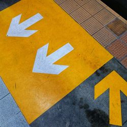 High angle view of arrow sign on road