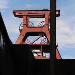 Low angle view of metal bridge against sky