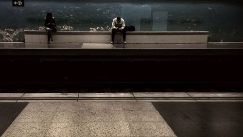 Full length of woman standing on railing