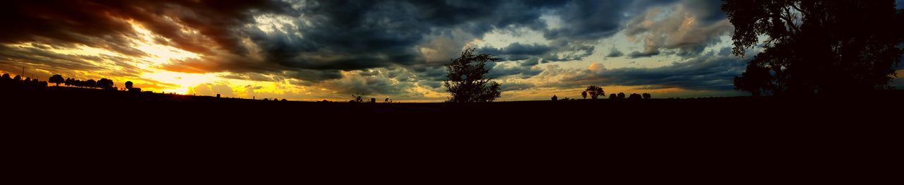 Silhouette of landscape against cloudy sky