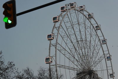 Low angle view of ferris wheel against sky