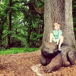 Portrait of boy with horse in the tree