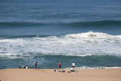 People on beach by sea