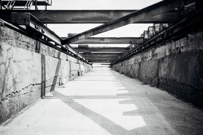 Empty footbridge leading to bridge