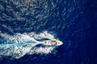 Aerial view of man driving motorboat in sea