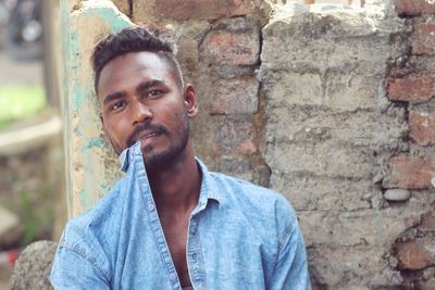 Portrait of young man smoking cigarette