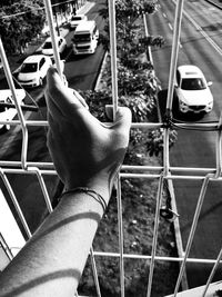 Cropped hand of person touching window