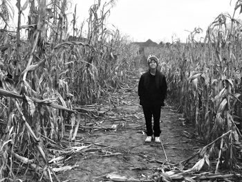 Full length of man standing on field against sky