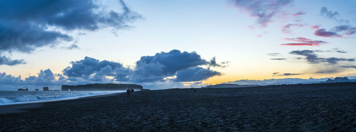 Scenic view of beach against sky during sunset